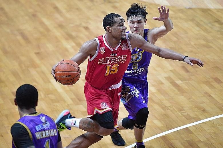 Singapore Slingers' Xavier Alexander attempts to make a play for his side amid the close attention of CLS Knights' Wong Wei Long during their Game 4 defeat by the Indonesian team. The championship-deciding Game 5 will be played at the OCBC Arena in S