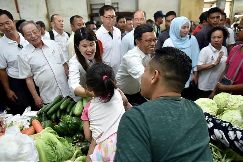 Democratic Action Party's Ms Vivian Wong at a market in Sandakan last week. She is flanked by Sabah Chief Minister Shafie Apdal (on her left), who is the head of Pakatan Harapan's partner Parti Warisan Sabah, and veteran DAP leader Lim Kit Siang.