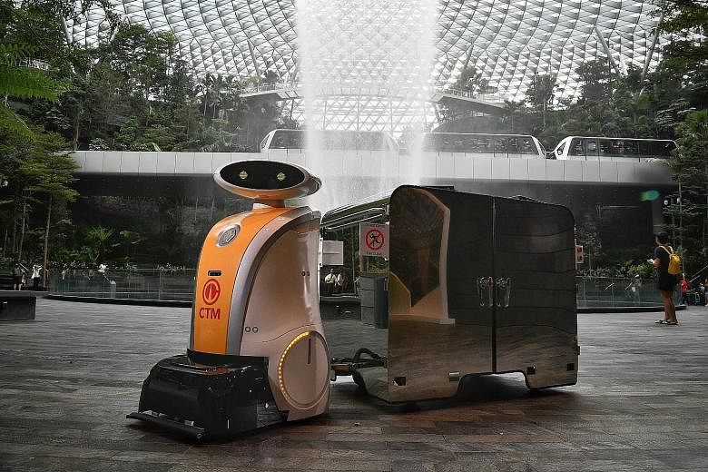 Yi Wei, a pull robot at Jewel Changi Airport, pulling a bin with a 1,000-litre capacity. Tenants can dispose of trash in the bin via an automated opening. 