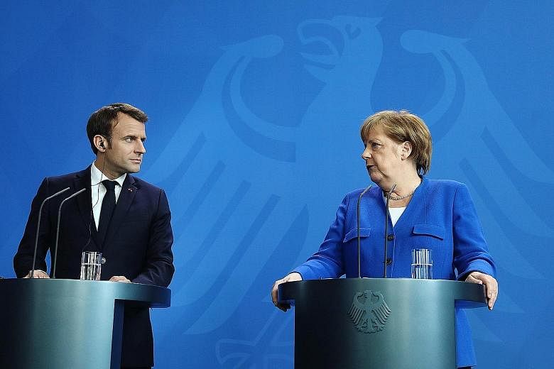 French President Emmanuel Macron and German Chancellor Angela Merkel at an event last month, before the start of the Balkan summit. Mr Macron has forecast that the German economic cycle is coming to an end.