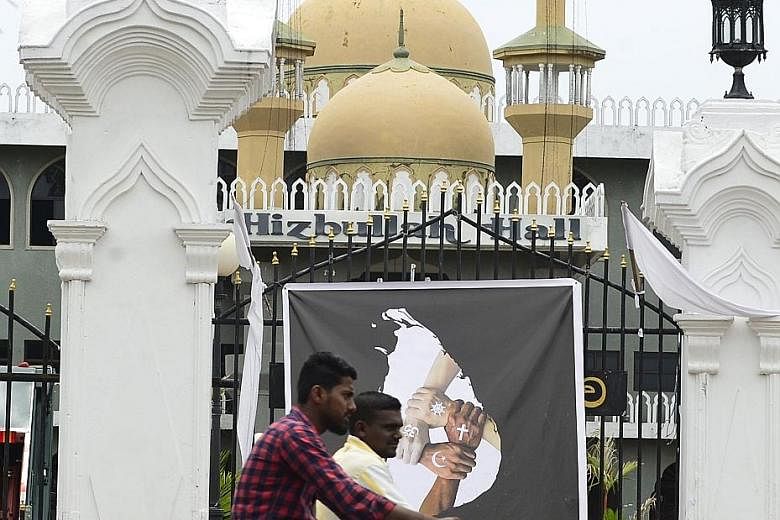 A poster showing four hands with different religious symbols. It was put up in honour of the victims of the Zion Church suicide bomb attack in Kattankudy on April 26. Sri Lanka had ignored the slow, deep process of radicalisation behind the attacks, 
