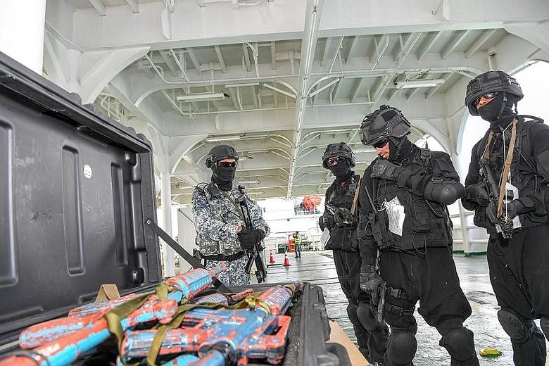Boarding teams from Brunei, India, South Korea and Singapore simulating a search on a vessel of interest as part of the exercise.