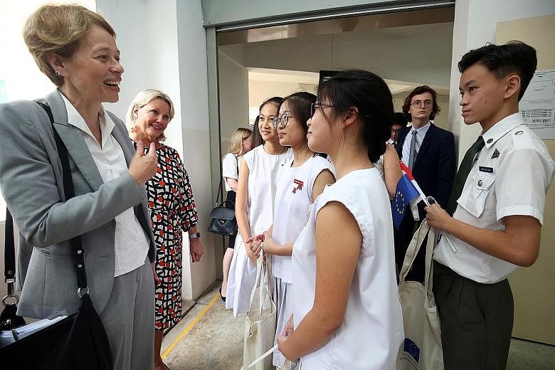 EU Ambassador to Singapore Barbara Plinkert (left) and Finnish Ambassador Paula Parviainen speaking to students after a panel discussion yesterday. European ambassadors will be visiting local schools to give talks on the EU.