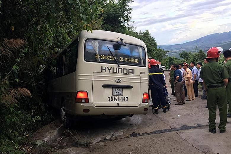 Emergency personnel at the scene of the accident in the central city of Hue, in Vietnam, last Saturday. One of the two buses carrying the students hit a kerb, and all 20 students on board were flung from their seats.