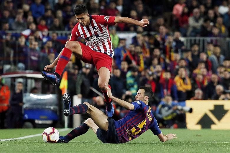 Atletico Madrid midfielder Rodri, evading a tackle by Barcelona's Sergio Busquets, is Manchester City's newest target. Whether he plays Champions League football next season with City is another question.