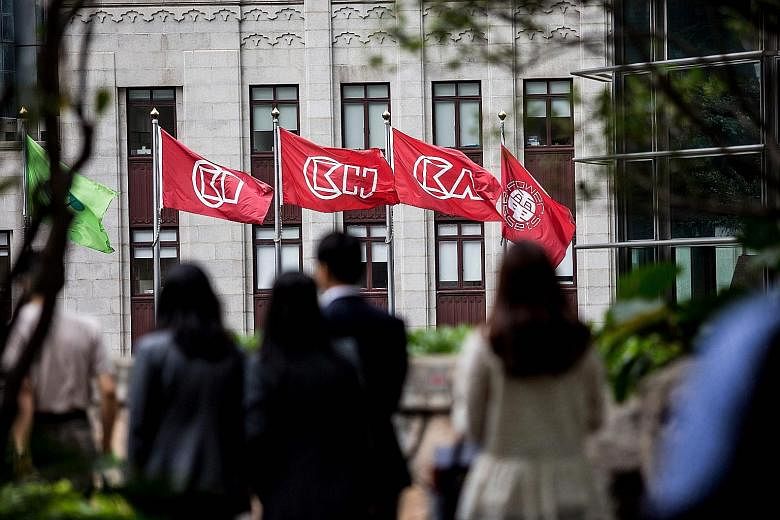 GMT Research says that by deeming a portion of its assets as held for sale, Hong Kong billionaire Li Ka Shing's CK Hutchison Holdings (flags of which are seen above, outside the company's headquarters in Hong Kong) may be hiding HK$57.7 billion (S$10