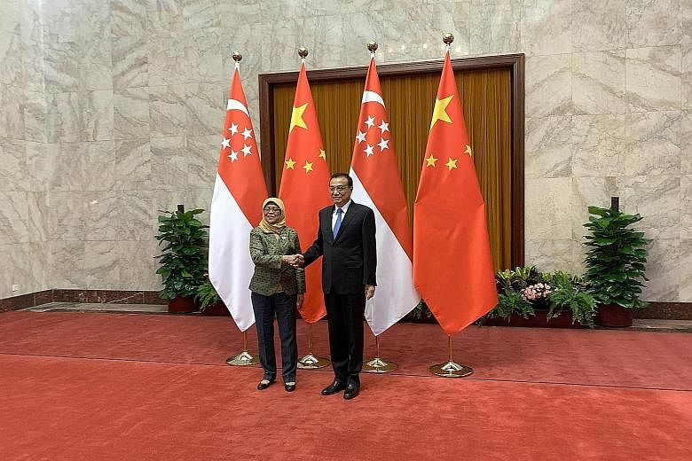President Halimah Yacob meeting Chinese Premier Li Keqiang at the Great Hall of the People in Beijing yesterday. Earlier in the day, she met Mr Wang Huning, Secretary of the Chinese Communist Party's Central Committee Secretariat, at Diaoyutai, the s