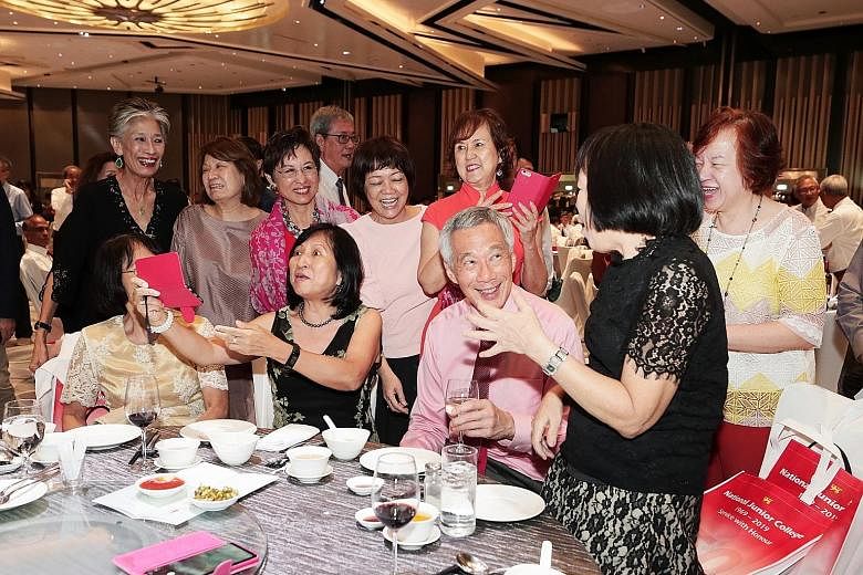 Prime Minister Lee Hsien Loong interacting with fellow 1969 pioneer batch students of the National Junior College. He was guest of honour at a gala dinner yesterday to mark the school's 50th anniversary.