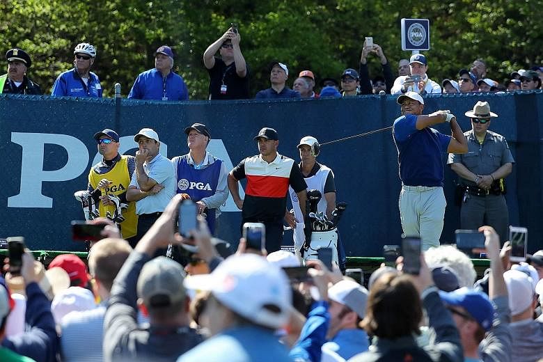 From right: Tiger Woods driving off from the 15th tee at the Bethpage Black course, watched by Brooks Koepka and Francesco Molinari during the first round of the 2019 PGA Championship on Thursday. PHOTO: AGENCE FRANCE-PRESSE