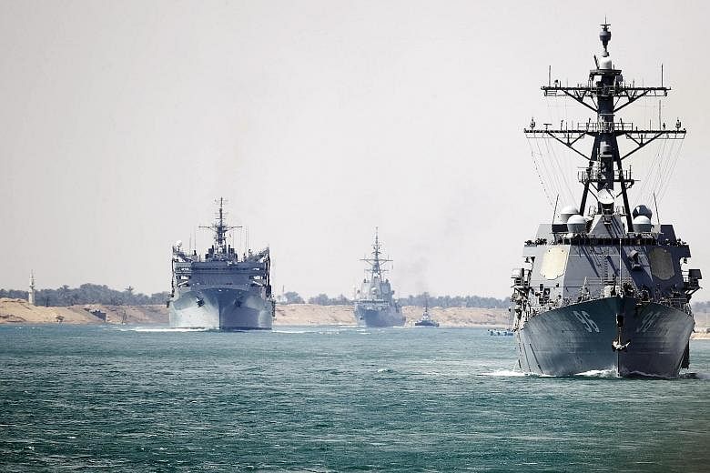 The aircraft carrier Abraham Lincoln and support vessels transiting the Suez Canal on May 9, en route to the Persian Gulf. US officials have raised concerns that Iran's Revolutionary Guards were targeting US naval ships in the area. PHOTO: NYTIMES