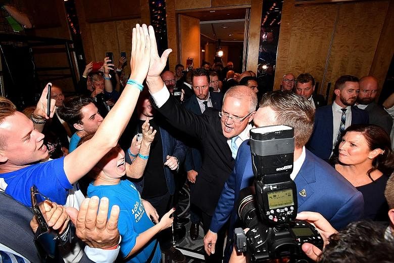 Australian Prime Minister Scott Morrison greeting supporters in Sydney after the ruling Coalition won in Saturday's polls. PHOTO: EPA-EFE