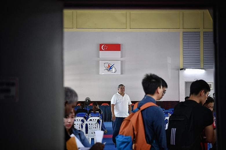 Attendees streaming in for the Singapore Taekwondo Federation extraordinary general meeting yesterday. ST PHOTO: ARIFFIN JAMAR
