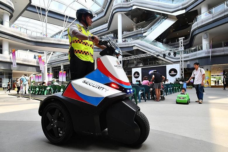 Security officer Mohamed Sidek patrolling Our Tampines Hub using a security Segway. Instead of armed power, the consensus among industry players is that it would be more effective to empower officers through better legal protection and to give the pr