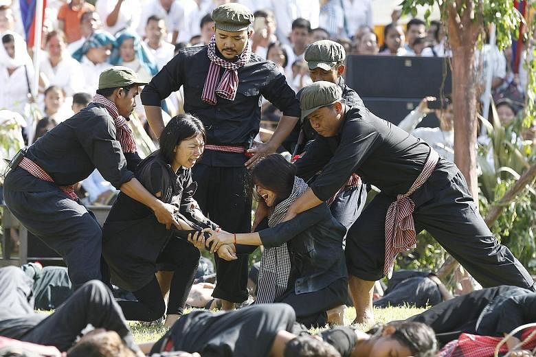 "Actors", including students, reenacting the horrors of the Khmer Rouge genocide in the 1970s at the "Killing Fields" yesterday to mark Cambodia's "Day of Anger".
