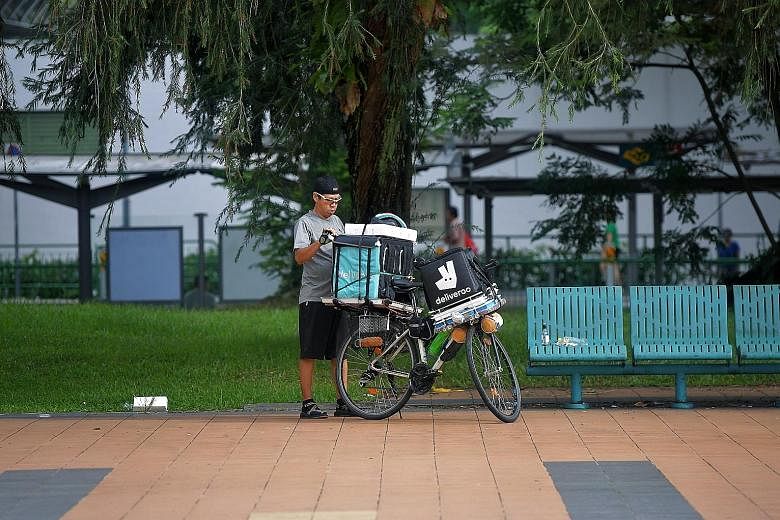 A Deliveroo delivery rider at Toa Payoh Central. Earlier this year, Deliveroo Singapore switched from a flat $3 delivery fee to a "variable" fee based on factors such as distance and the time it takes the rider to deliver. ST PHOTO: KUA CHEE SIONG