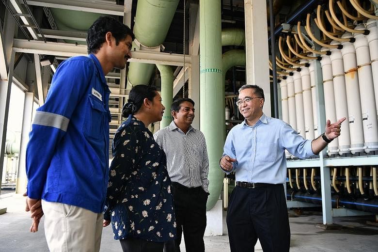 (From right) PUB's director of water supply (plants) Bernard Koh speaking to Tuaspring's senior manager for operations and maintenance (water) Krishnamoorthy Chandrasekar; senior quality environmental, health and safety manager Hamidah Mohd Razak; an