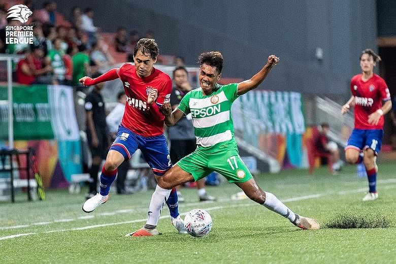 Warriors FC forward Gabriel Quak (in red) vying with Geylang International's Firdaus Kasman during a Singapore Premier League match last month. The Warriors are bottom of the standings, behind the Young Lions on goal difference. PHOTO: SINGAPORE PREM