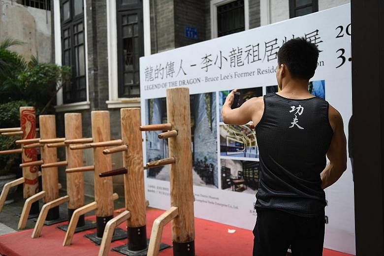 The former residence of Bruce Lee's family in Yongqing Fang, Guangzhou, has been turned into a museum (far left) for the martial arts legend after a demolition plan was derailed by calls for conservation. A Bruce Lee mural (left) in Yongqing Fang.