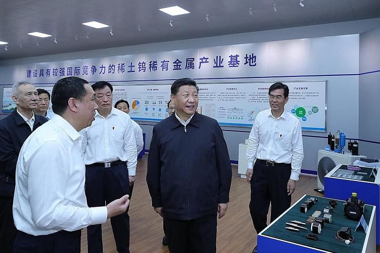 Chinese President Xi Jinping (centre), with Vice-Premier Liu He (far left, wearing black jacket), on a visit to a manufacturer of magnetic materials made of the neodymium rare earth in Ganzhou, Jiangxi province, on Monday.