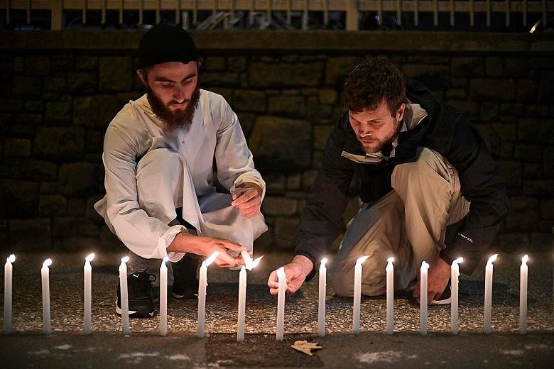 Well-wishers paying respects to victims outside a hospital in Christchurch on March 16 after the mosque shootings. Religious leaders must not deny that religions can motivate violence, says the writer.