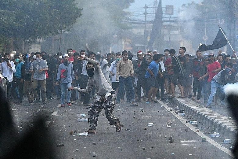 Protesters hurled Molotov cocktails, firecrackers and other projectiles at police officers during the clashes in Jakarta, causing widespread disruptions, including road diversions and the suspension of train and bus services. Protesters, some armed w