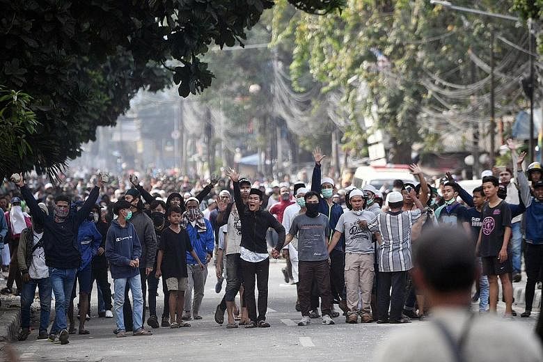Protesters hurled Molotov cocktails, firecrackers and other projectiles at police officers during the clashes in Jakarta, causing widespread disruptions, including road diversions and the suspension of train and bus services. Protesters, some armed w