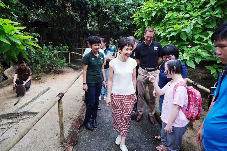 Ms Vivian Wong, 31, a beneficiary of the Movement for the Intellectually Disabled of Singapore, chatting with Minister for Culture, Community and Youth Grace Fu at the Night Safari's wallaby enclosure yesterday. Ms Wong was one of about 50 beneficiar