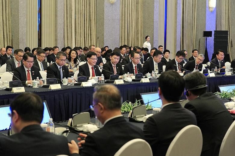Deputy Prime Minister Heng Swee Keat (third from left) delivering the opening address at the inaugural Singapore-Shanghai Comprehensive Cooperation Council meeting yesterday. The council, which Mr Heng co-chairs with Shanghai Mayor Ying Yong, is Sing