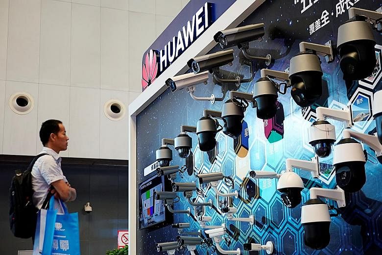 Surveillance cameras at Huawei's booth at a security exhibition in Shanghai. The Trump administration is seeking to choke off Beijing's access to key technologies by limiting the sale of vital US components to the Chinese telecommunications equipment
