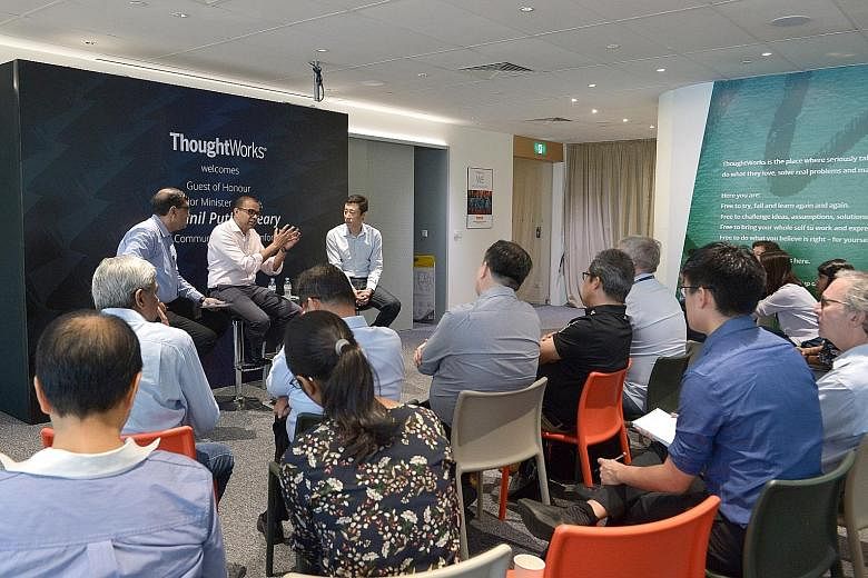 Senior Minister of State for Communications and Information Janil Puthucheary speaking at yesterday's dialogue, flanked by moderator Amit Roy Choudhury (left) and ThoughtWorks CEO Guo Xiao. Dr Janil cited various initiatives that demonstrate tech fir
