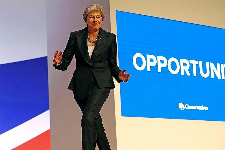 Britain's Prime Minister Theresa May jiving to Abba's Dancing Queen as she arrived for the final day of the Conservative Party conference in Birmingham last October. PHOTO: REUTERS