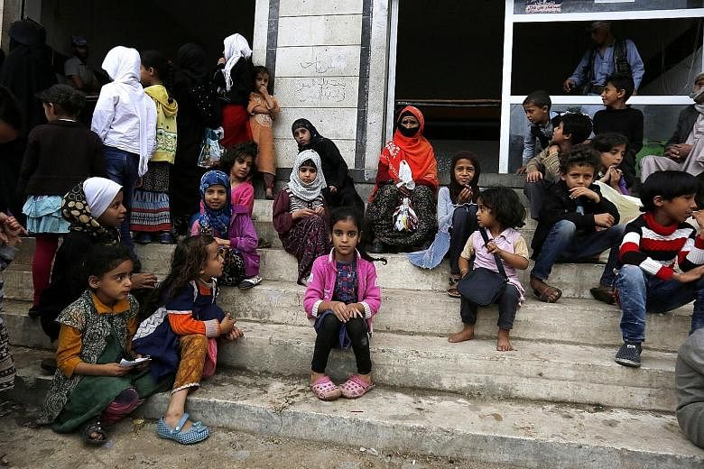 Women and children waiting for food rations from a charity kitchen in Sana'a this month. A four-year conflict in Yemen has been deemed by the UN to be the world's worst humanitarian crisis, with thousands of civilians killed and millions suffering fr