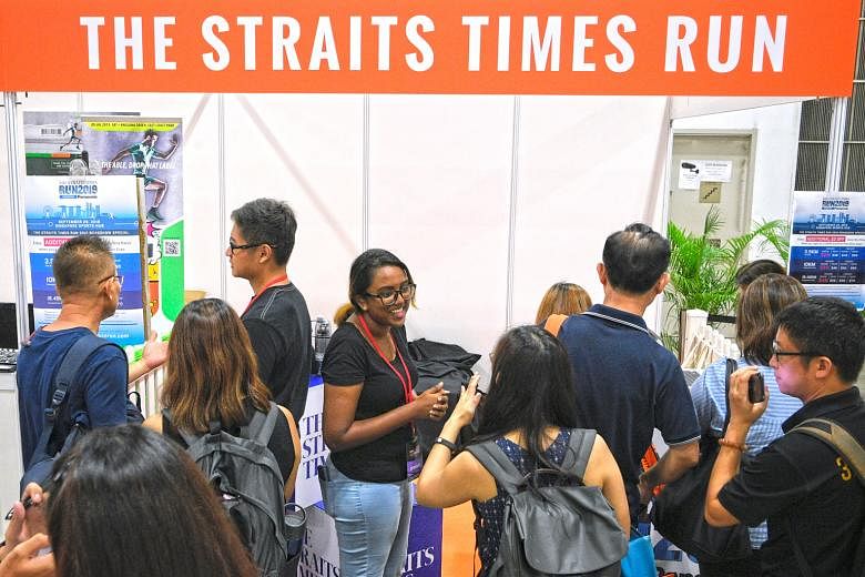 Runners signing up for the 2019 The Straits Times Run at the Osim Sundown Marathon Expo at Marina Bay Sands Expo and Convention Centre Hall C yesterday. Those who sign up by June 16 for the individual 3.5km (originally $50), 10km ($60) and 18.45km ($