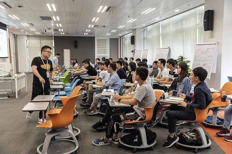 New employees attending a class at Huawei's training facility, in Dongguan, China. The company may have to lay off thousands of people and "disappear as a global player for some time", says an analyst who tracks the chip industry. PHOTO: BLOOMBERG