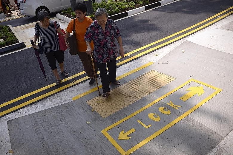 A Silver Zone crossing in Bukit Merah. These zones, with narrowing roads and wider centre dividers, were introduced in 2014 to make it safer for seniors crossing roads. The Land Transport Authority is planning to lower the road speed limit in some zo