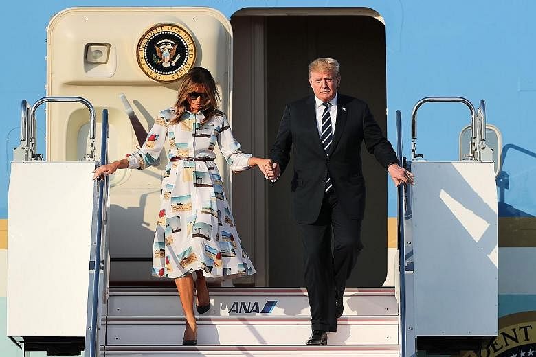 US President Donald Trump and his wife, Mrs Melania Trump, disembarking from Air Force One at Haneda International Airport in Tokyo yesterday. They are in Japan for a largely ceremonial four-day state visit.