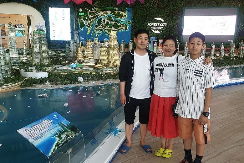 Johor resident Hanafi Mohamed Zin says entering Forest City is like entering China, with many shops selling Chinese goods. Chinese businesswoman Yang Ping visiting Forest City in Johor with her husband Chen Xu and their son Jim Chen earlier this mont