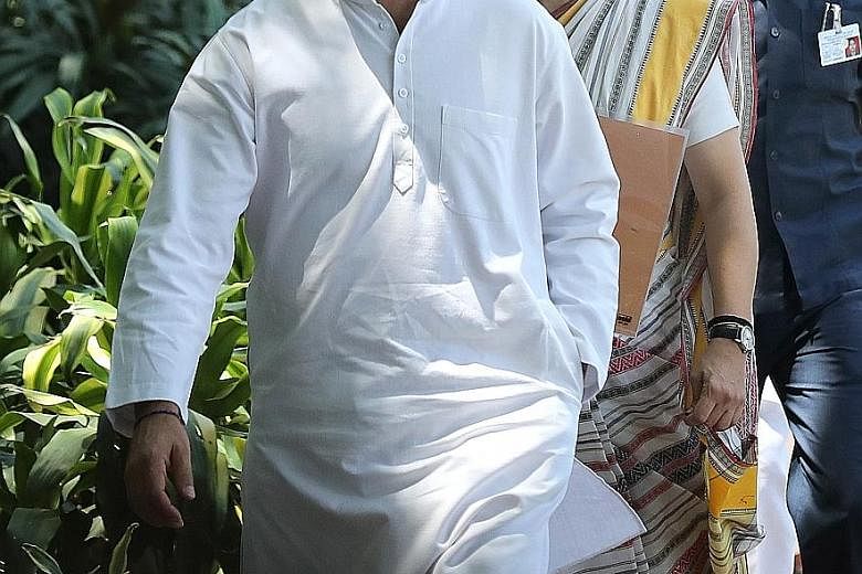 Congress party president Rahul Gandhi and his sister Priyanka arriving for yesterday's meeting at the opposition party's headquarters in New Delhi.