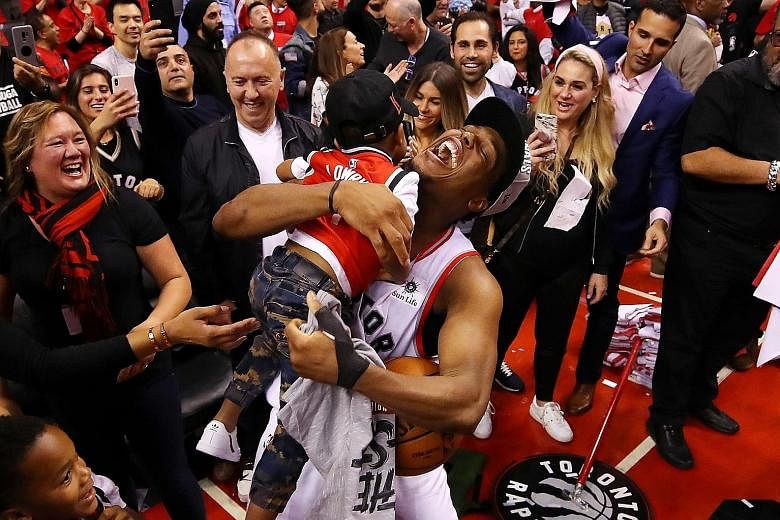 Left: Raptors guard Kyle Lowry celebrating qualification for the NBA Finals with his sons. He described his fellow All-Star teammate Kawhi Leonard as a "monster" for his several clutch plays down the stretch. Leonard battling for the ball in Game 6 o