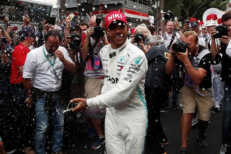 Lewis Hamilton is generous in spraying his winner's champagne after the Monaco Grand Prix. The Briton was struggling with his tyres, having fitted softer medium ones than his rivals. PHOTO: REUTERS