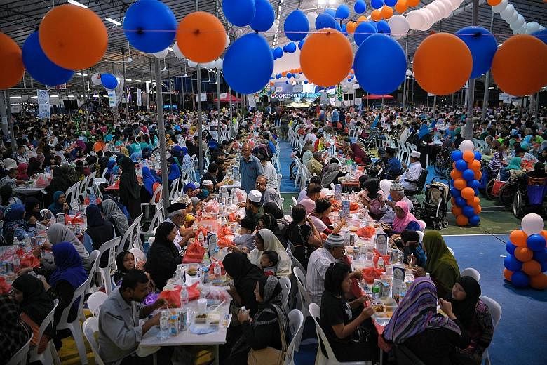 Residents of different races and religions joining their Muslim compatriots in breaking fast at Kampong Ubi Community Centre yesterday. The event, Harmony Iftar 2019, involved close to 4,000 residents from the Marine Parade cluster, with President Ha