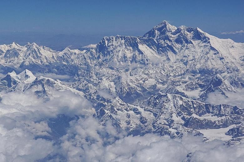 Climbers descend from the summit of Everest down the Hillary Step and across the cornice traverse to the South Summit. This has been one of the deadliest climbing seasons on Everest, with at least 10 dead or missing. Veteran climbers and industry lea