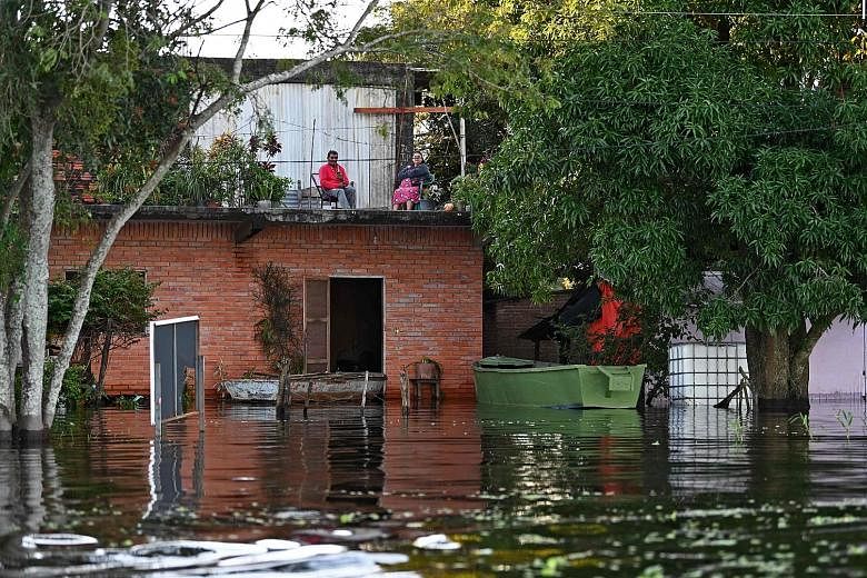Some residents have opted to remain in their flooded homes in Puerto Falcon, near the capital Asuncion, despite water levels on the Paraguay River rising.