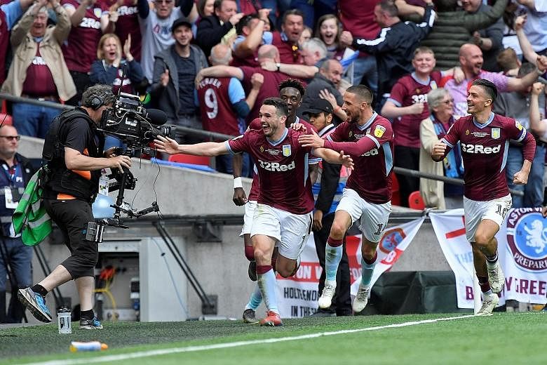 Aston Villa's John McGinn celebrates scoring their second goal that proved to be the difference in the Championship play-off final against Derby.