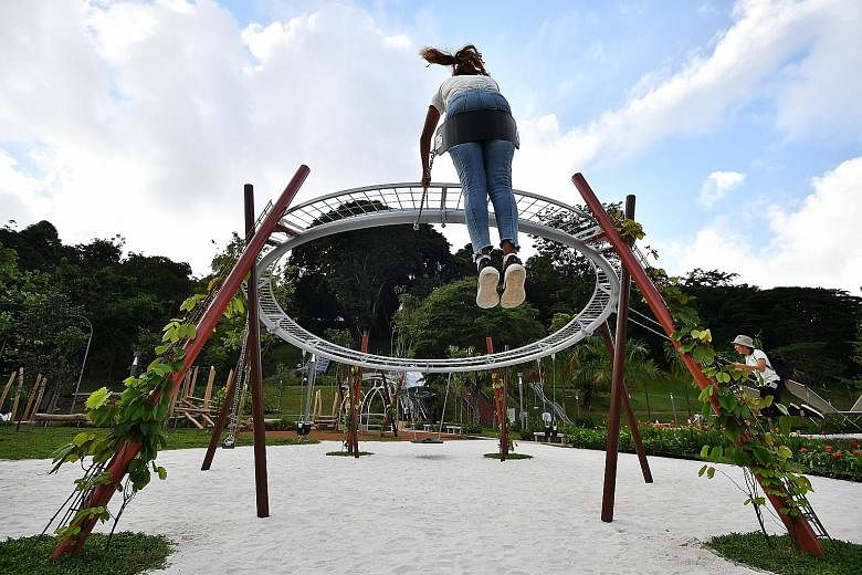 This green space at the foot of Fort Canning Hill has been restored as a family-friendly spot where children can play on swings, see-saws, logs and slides hugging the hill slope. ST PHOTO: LIM YAOHUI