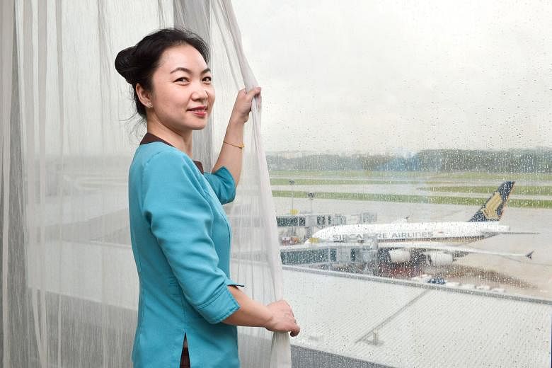 Room assistant Yuan Ai Hong by one of the hotel room windows in Crowne Plaza Changi Airport that have sensors that alert security if the windows are being tampered with. Earlier this month, the hotel became the first in Singapore to take part in Exer