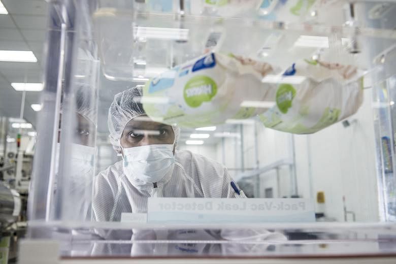 An employee carrying out quality inspection at Kimberly-Clark's Tuas plant. Last year, the baby products maker pumped $18 million into the factory to double its output capacity and set up a lab to boost product innovation.
