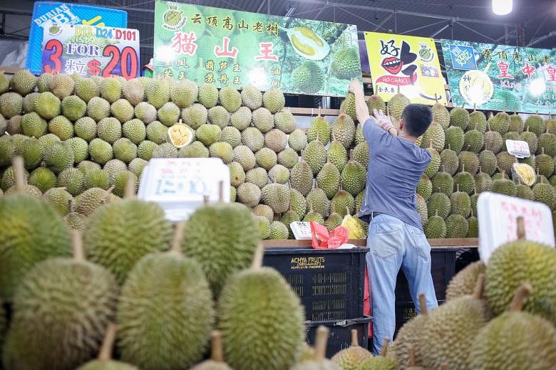 Mao Shan Wang durians are now going for about $18 a kilogram, down from the usual price of $28, following an increase in supply from Malaysia. ST FILE PHOTO