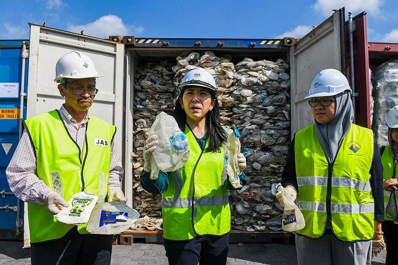 Malaysia's environment minister Yeo Bee Yin (centre) showing samples of plastic waste from Australia yesterday.