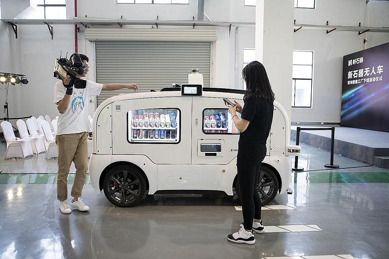 An autonomous vending-machine vehicle at a launch event at Neolix's facility in Changzhou city in China last Friday. The Chinese start-up kicked off mass production of its self-driving delivery vehicles - saying it is the first company globally to do